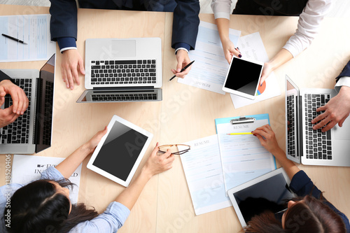 Group of business people working at desk, top view