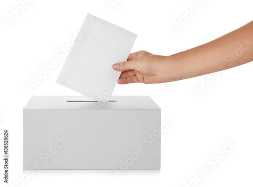 Female hand putting voting ballot into the box on white background