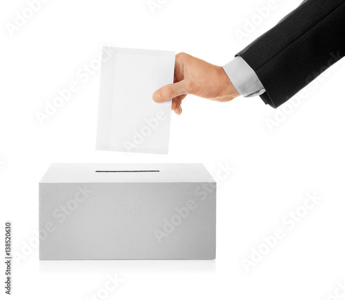 Konstfotografi Male hand putting voting ballot into the box  on white background