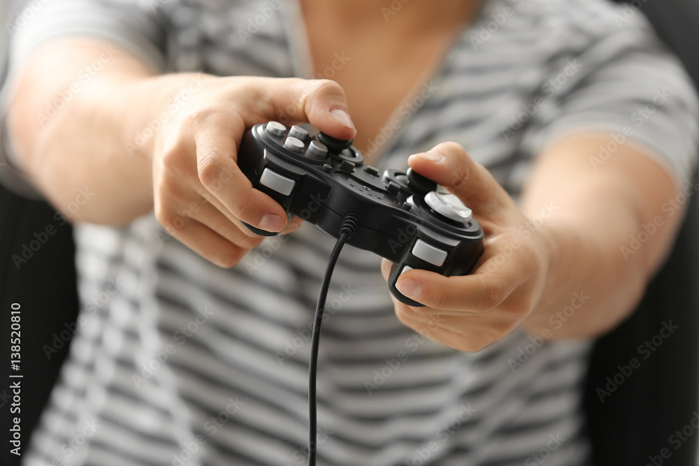 Teenager playing videogame at home, closeup Teenager playing videogame at home, closeup