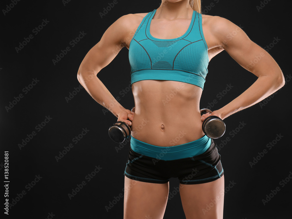 Young athletic woman with dumbbells on black background, closeup Young athletic woman with dumbbells on black background, closeup