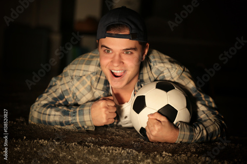 Teenager watching football ...