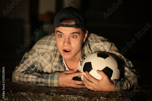 Teenager watching football ...