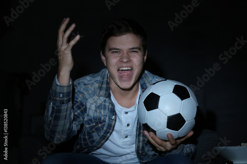Teenager watching football ...