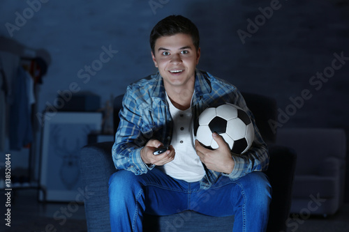 Teenager watching football ...