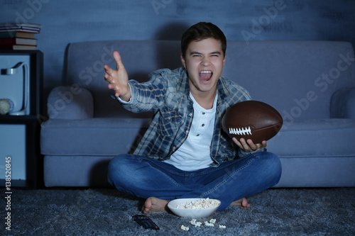 Teenager watching rugby lat...