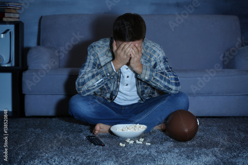 Teenager watching rugby lat...