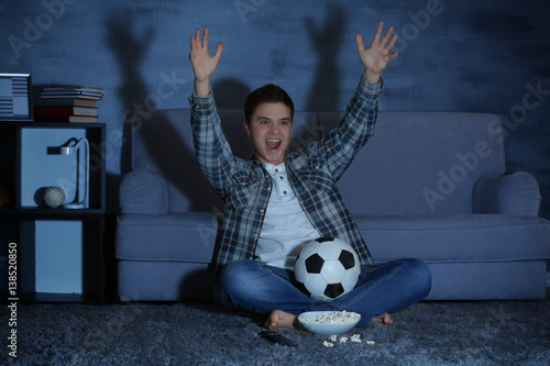 Teenager watching football ...