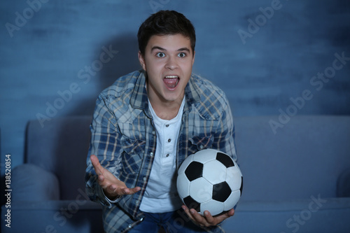 Teenager watching football ...