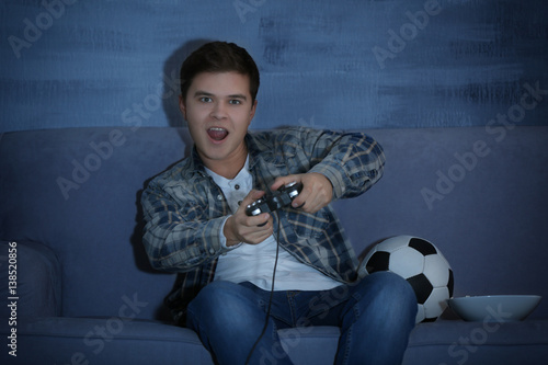Teenager playing videogame ...