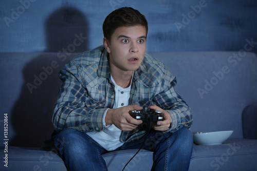 Teenager playing videogame ...