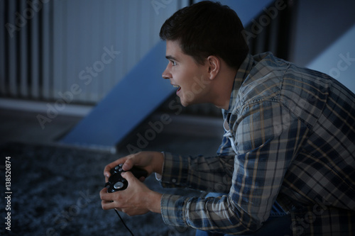 Teenager playing videogame ...