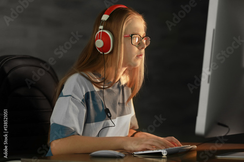 Pretty teenager playing com...