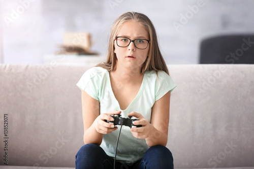 Pretty teenager playing vid...