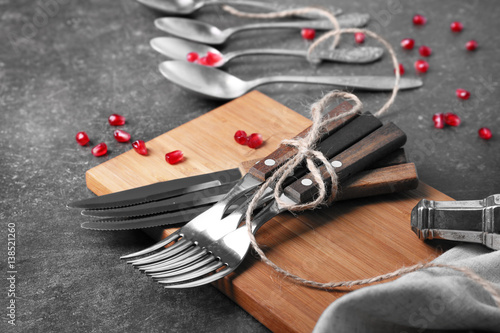 Cutlery set and garnet on gray table