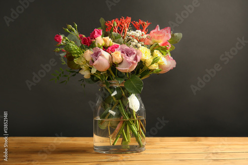 Wallpaper Mural Glass vase with beautiful bouquet of  flowers on wooden table and black background Torontodigital.ca