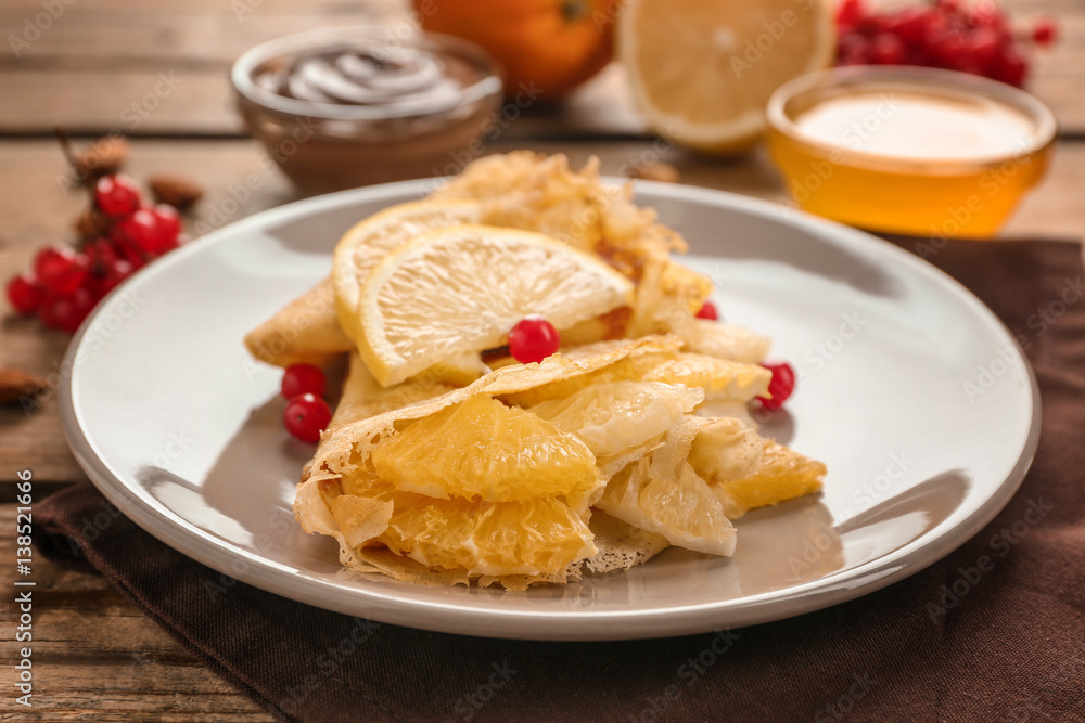 Tasty pancakes with citrus fruits on wooden table Tasty pancakes with citrus fruits on wooden table