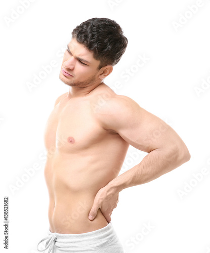 Young man suffering from backache on white background