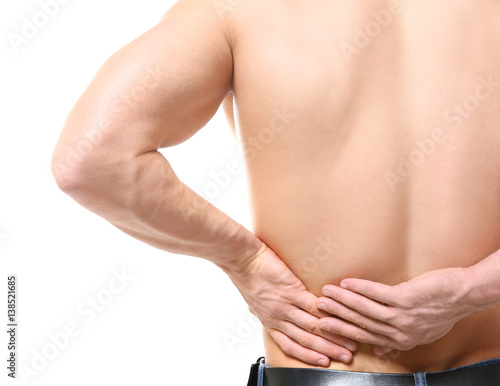 Young man suffering from backache on white background  closeup