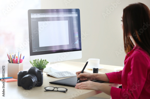 Young female designer worki...