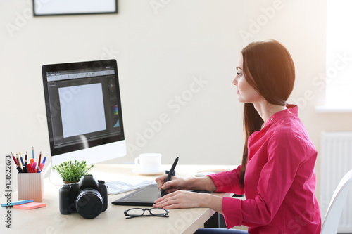 Young female designer worki...