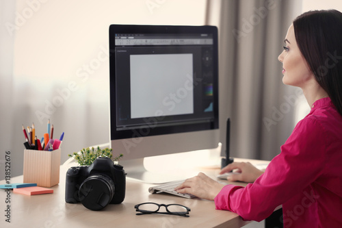Young female designer worki...