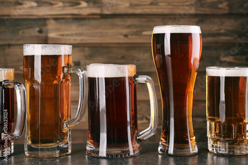 Glasses with beer on wooden background