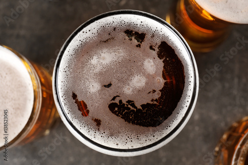 Glasses with beer on gray background