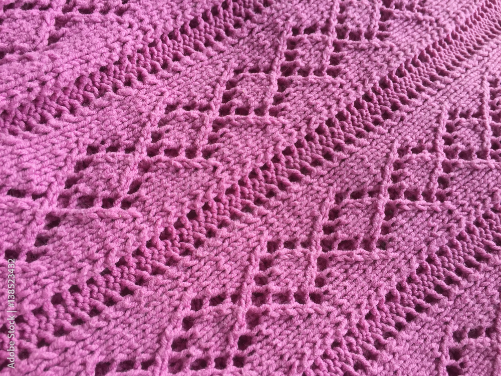 Close-up background of hand-knitted textured detail. Beautiful artistic surface