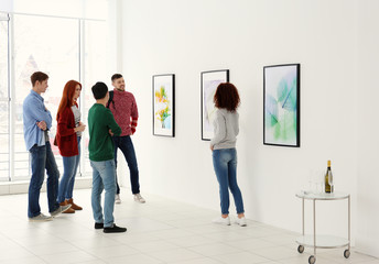 Young people in modern art gallery hall