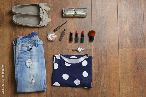 Flat lay set of female clothes and accessories on wooden background