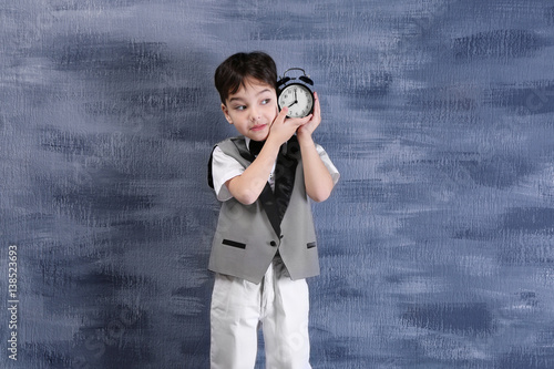 Cute little boy with alarm ...