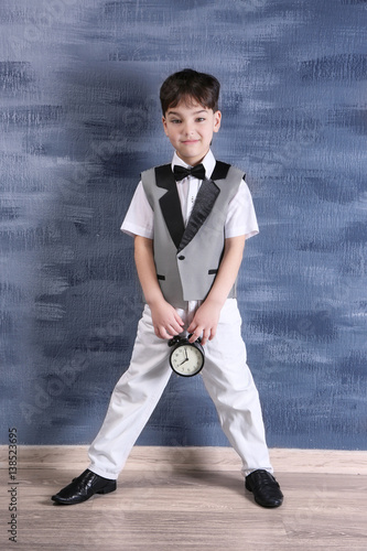 Cute little boy with alarm ...