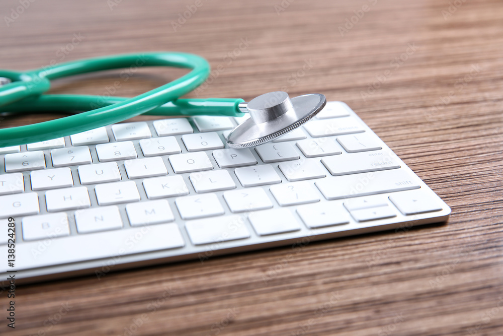 Stethoscope on computer keyboard, closeup Stethoscope on computer keyboard, closeup