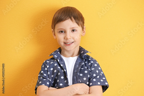 Cute little boy on color ba...