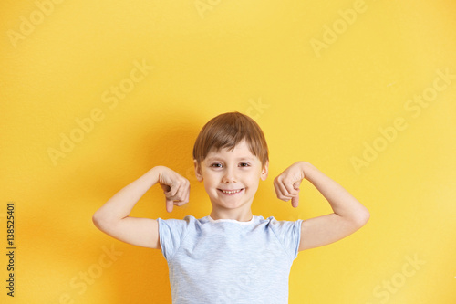 Cute little boy on color ba...