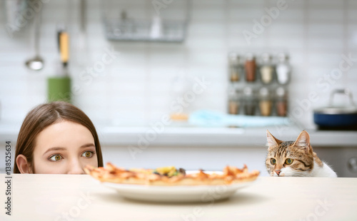 Young woman and cute cat lo...