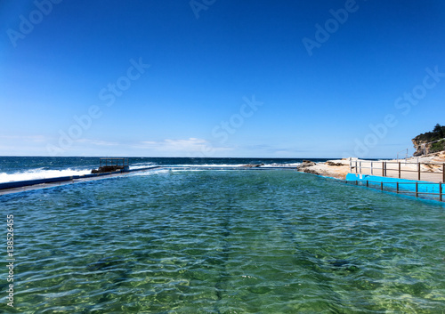 Rock swimming pool flowing into the Pacific Ocean