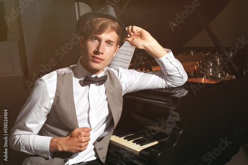 Young musician posing near ...