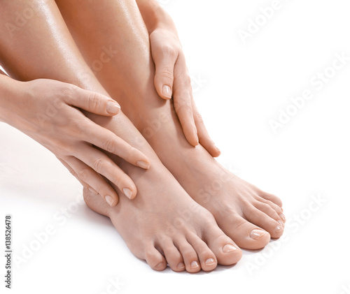 Female hands and legs on white background