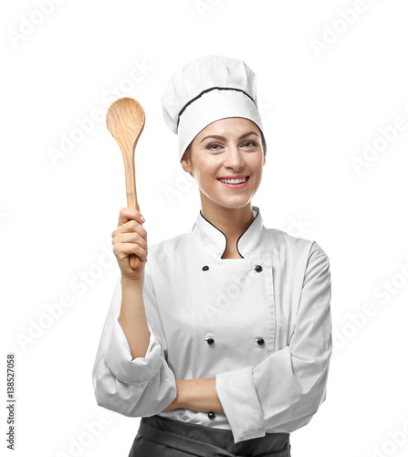 Portrait of female chef with wooden spoon isolated on white photo