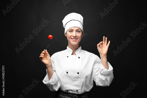 Portrait of female chef hol...