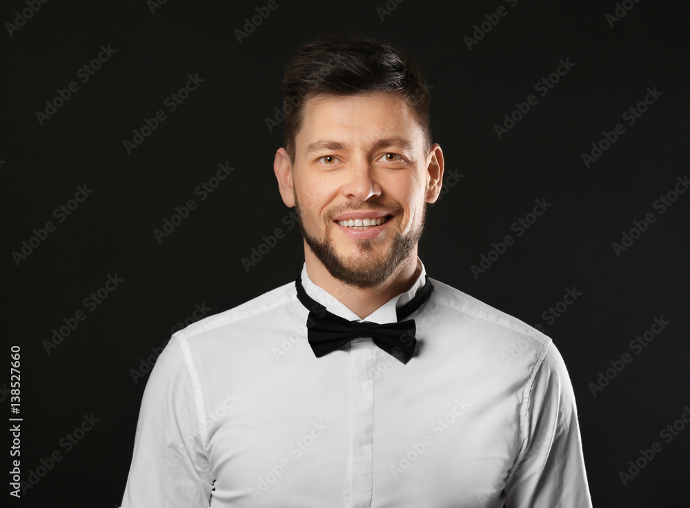 Handsome young man posing on dark background Handsome young man posing on dark background