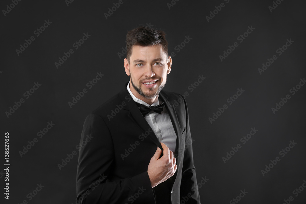 Fototapeta premium Handsome young man posing on dark background