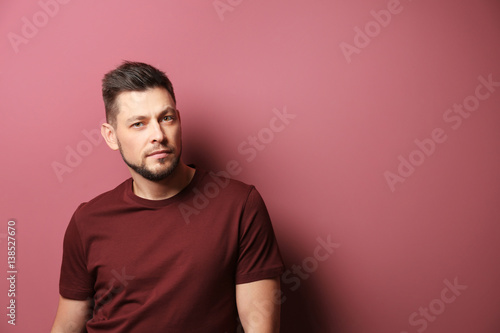 Handsome young man posing on color background © Africa Studio