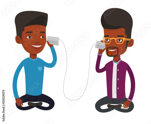 Young friends talking through tin phone.