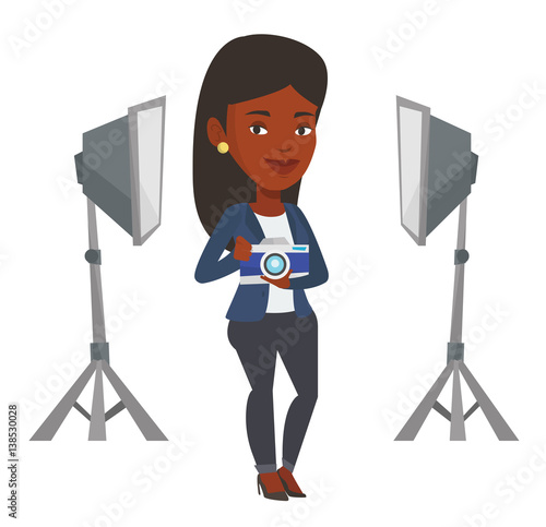 Photographer with camera in photo studio.