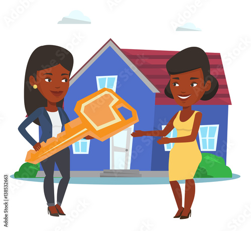 Real estate agent giving key to new house owner.