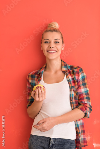 woman over color background plays with apple