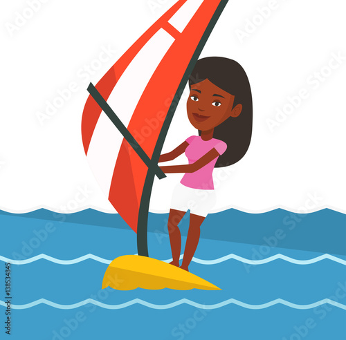 Young woman windsurfing in the sea.